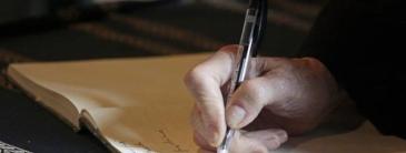 Image of a person hand writing in a notebook