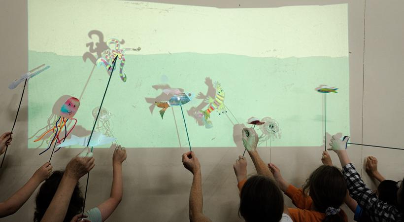 Children with shadow puppets