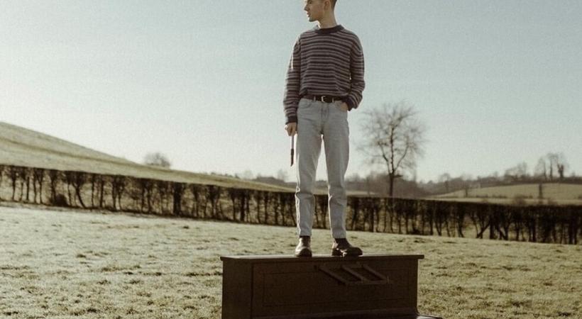 Image of Jamie Duffy on a piano