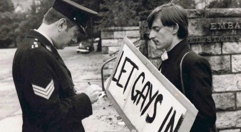 A guard and a man with a protest banner