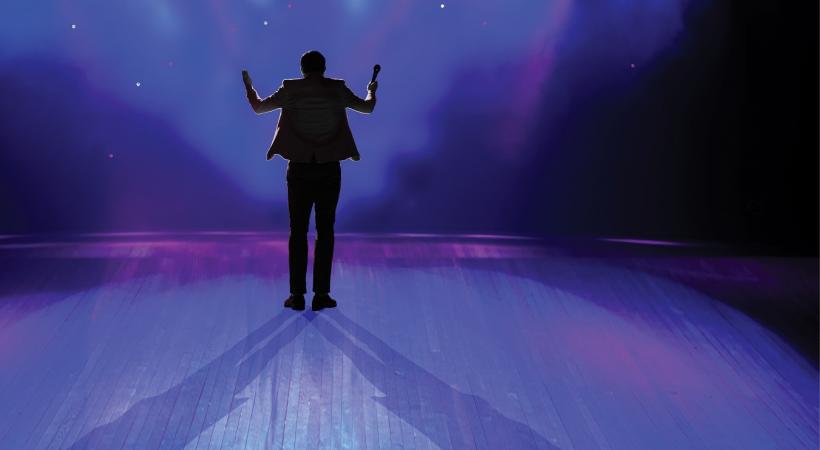 Man on stage with background lights